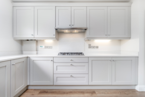 a kitchen with numerous white appliances and cabinets