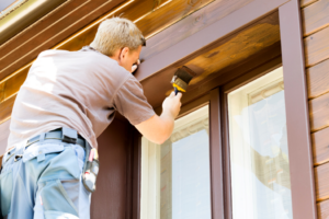 a person painting a home’s exterior